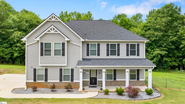 view of front of property with covered porch and a front yard