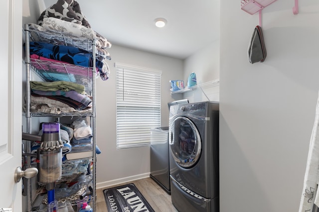 laundry room featuring washer / dryer and light hardwood / wood-style floors