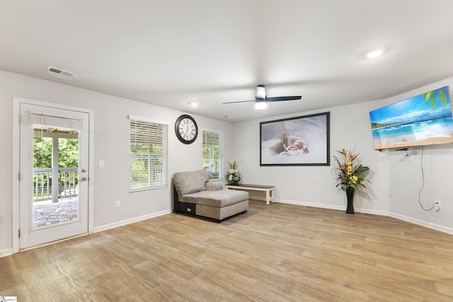 sitting room with plenty of natural light, ceiling fan, and light wood-type flooring