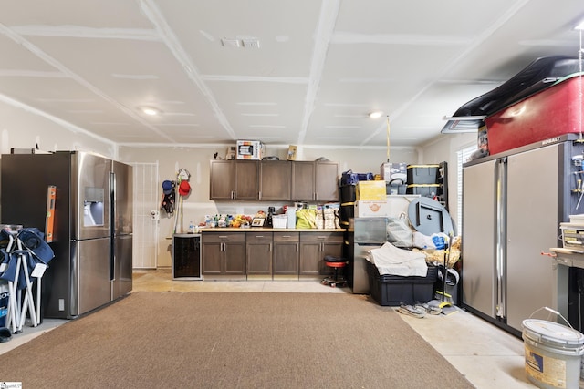 interior space featuring stainless steel refrigerator and stainless steel fridge with ice dispenser