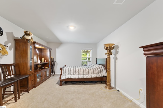 bedroom featuring light carpet