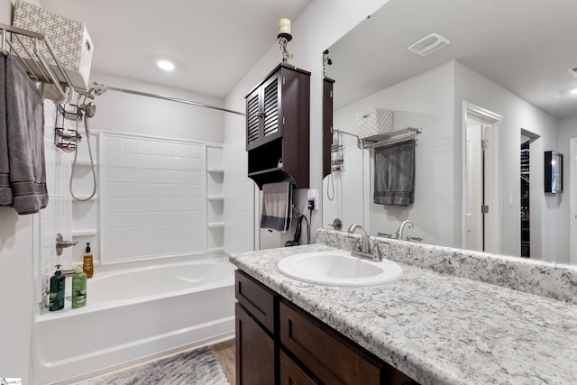 bathroom featuring hardwood / wood-style flooring, vanity, and shower / bathtub combination