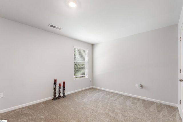 unfurnished room featuring light carpet