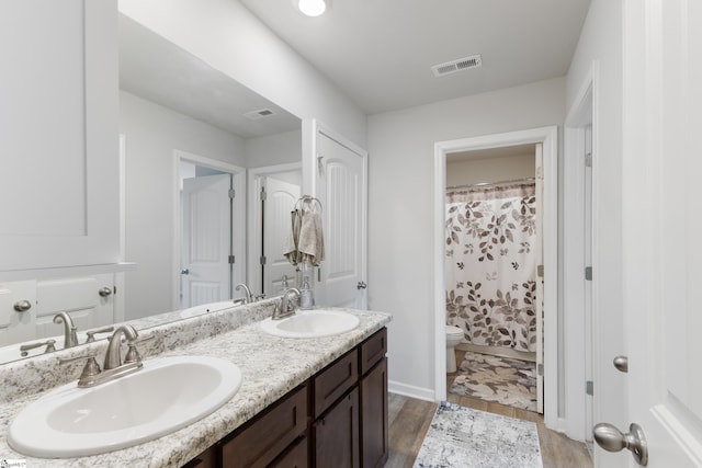 bathroom with hardwood / wood-style flooring, vanity, toilet, and a shower with curtain