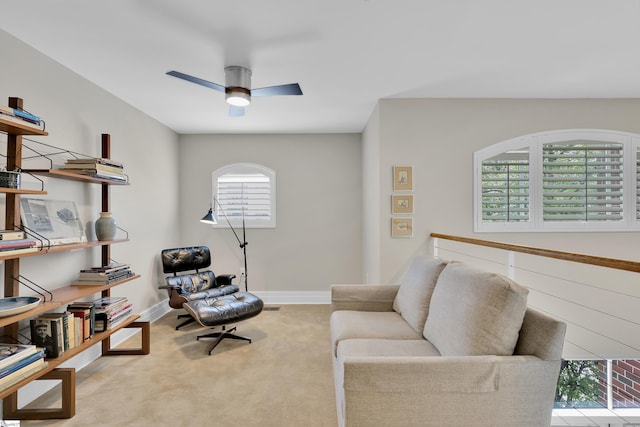 sitting room featuring ceiling fan and light colored carpet