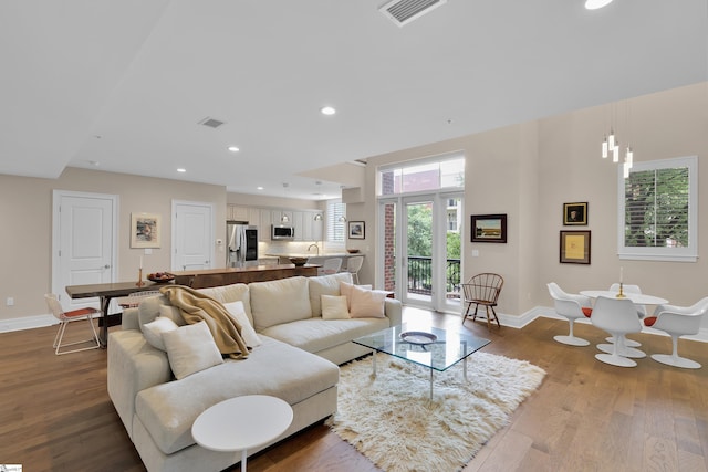 living room featuring hardwood / wood-style floors and a chandelier