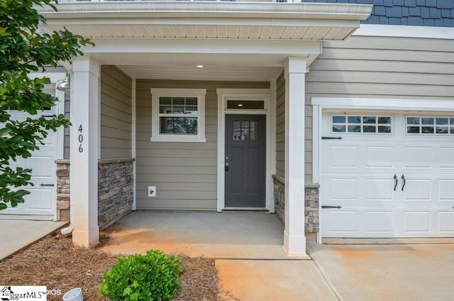 property entrance featuring a garage and covered porch