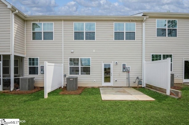 back of house featuring central air condition unit, a yard, and a patio