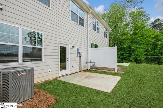 back of house with a yard, a patio, and central air condition unit