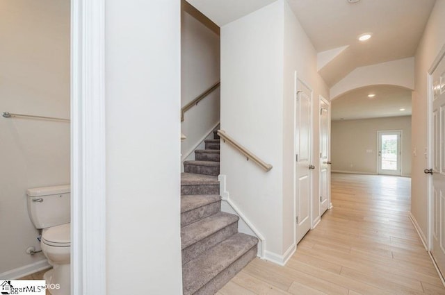 stairs featuring hardwood / wood-style flooring