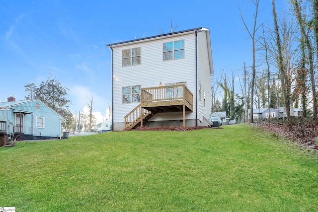 rear view of house featuring a deck and a yard