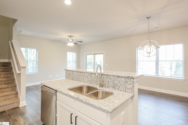 kitchen featuring white cabinets, dishwasher, light stone counters, and sink