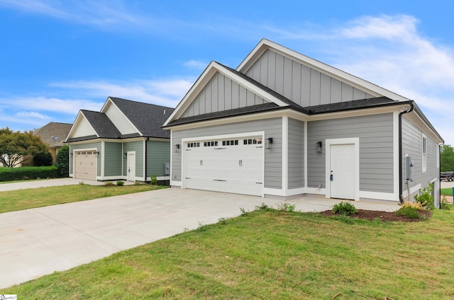 craftsman house with a front lawn and a garage