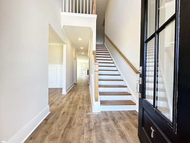 entrance foyer featuring crown molding and wood-type flooring