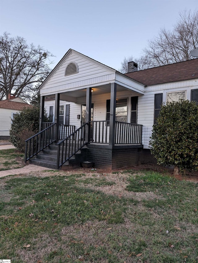 view of front facade with a front lawn and a porch