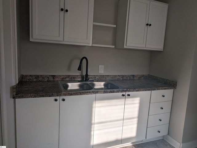 kitchen with white cabinetry and sink