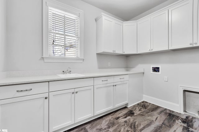 washroom featuring washer hookup, sink, and cabinets