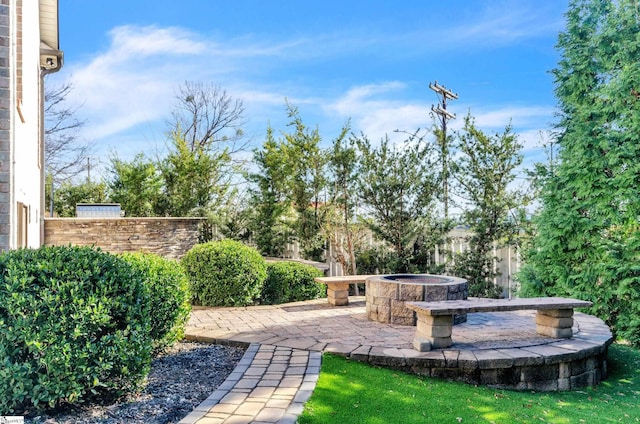 view of yard with an outdoor fire pit and a patio