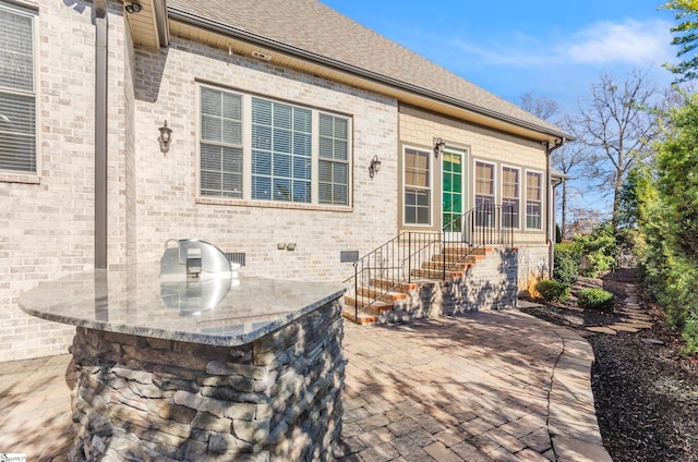 view of patio with exterior kitchen and an outdoor bar