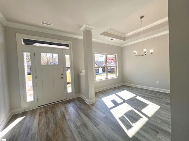 entrance foyer featuring ornamental molding, visible vents, baseboards, and wood finished floors