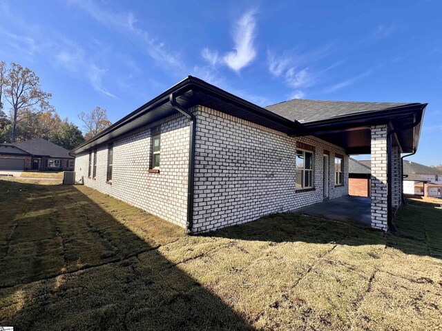 view of home's exterior with a patio area and brick siding