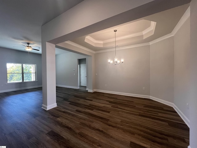 interior space with ceiling fan with notable chandelier, a tray ceiling, dark hardwood / wood-style floors, and ornamental molding