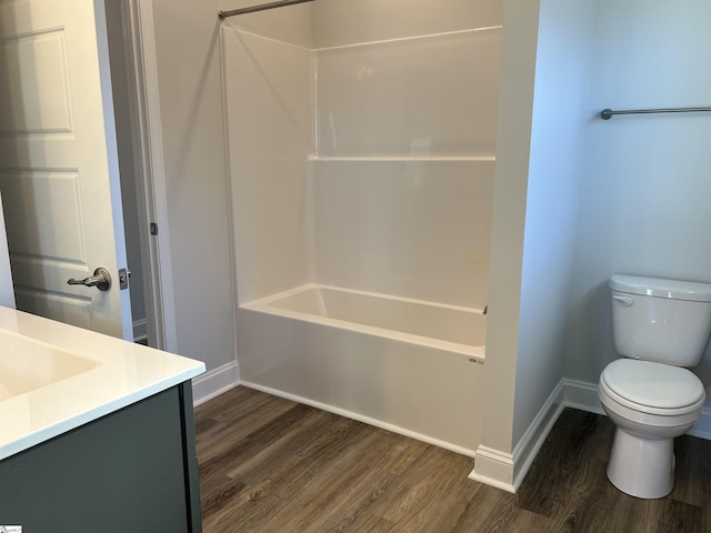 full bathroom with toilet, shower / washtub combination, hardwood / wood-style flooring, and vanity