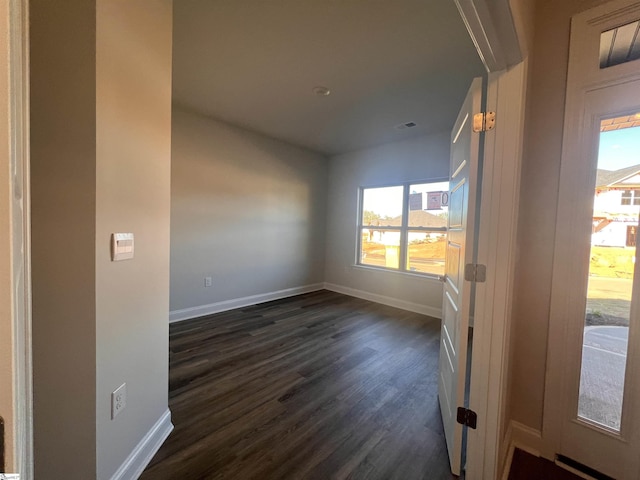 spare room with dark hardwood / wood-style flooring