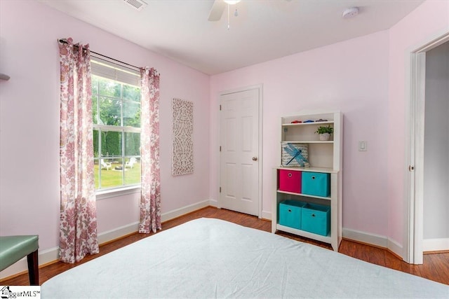 bedroom with ceiling fan and wood-type flooring