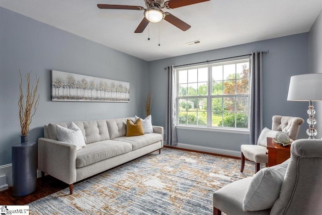 living room featuring hardwood / wood-style floors and ceiling fan