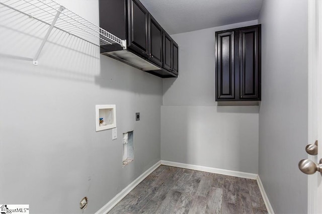 washroom featuring hardwood / wood-style flooring, hookup for a washing machine, cabinets, and hookup for an electric dryer