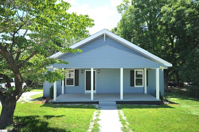 bungalow-style house with a front lawn and covered porch