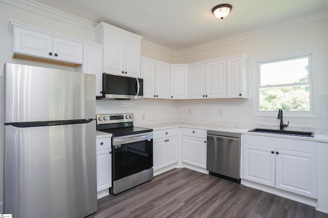 kitchen featuring sink, stainless steel appliances, dark hardwood / wood-style flooring, crown molding, and white cabinets