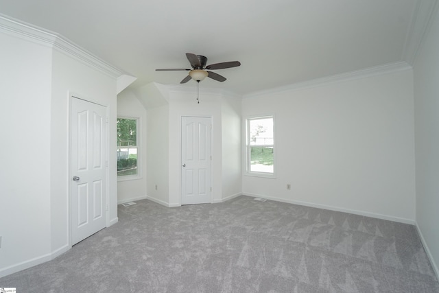 spare room with light colored carpet, ceiling fan, and ornamental molding