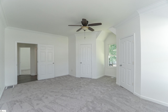 unfurnished bedroom featuring light carpet, ceiling fan, and ornamental molding