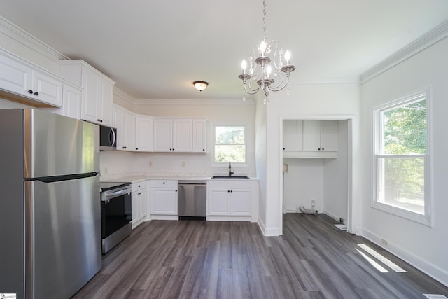 kitchen with stainless steel appliances, white cabinetry, a healthy amount of sunlight, and sink