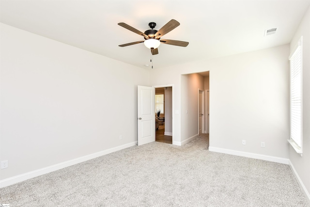 spare room with carpet flooring and ceiling fan