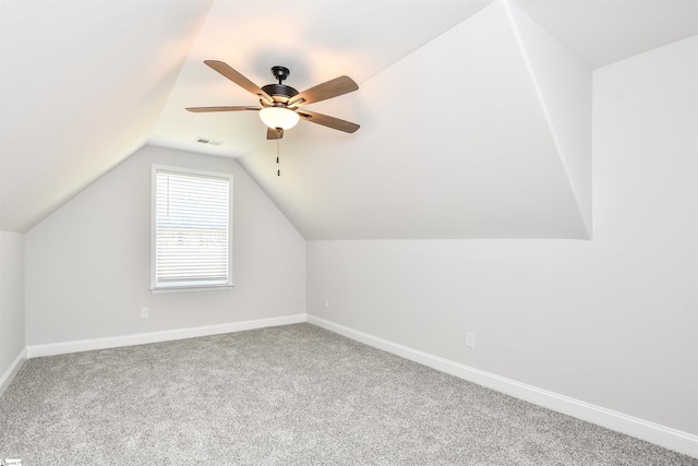 additional living space with carpet flooring, vaulted ceiling, and ceiling fan