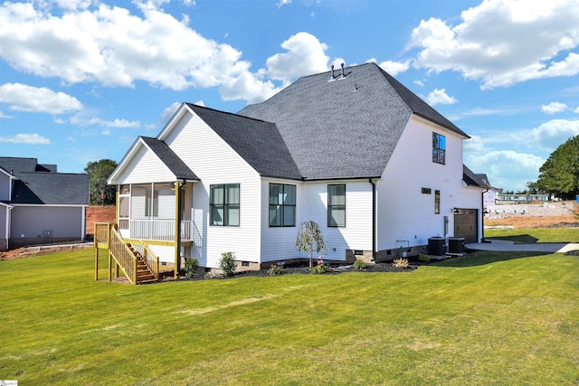 back of property with a yard and central air condition unit