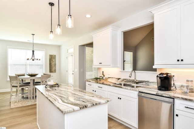 kitchen with pendant lighting, dishwasher, and light hardwood / wood-style flooring