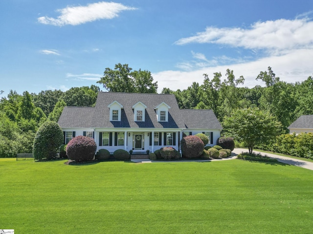 new england style home with a porch and a front yard