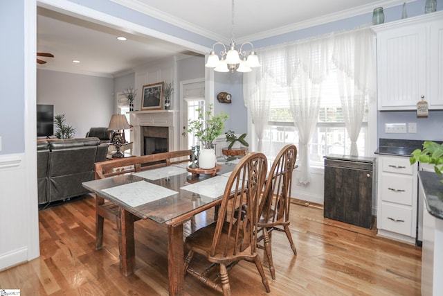 dining room featuring ceiling fan with notable chandelier, crown molding, and light hardwood / wood-style flooring