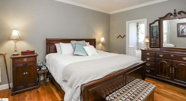 bedroom with hardwood / wood-style floors, connected bathroom, and crown molding