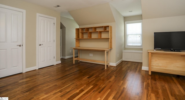 interior space with dark hardwood / wood-style flooring and vaulted ceiling