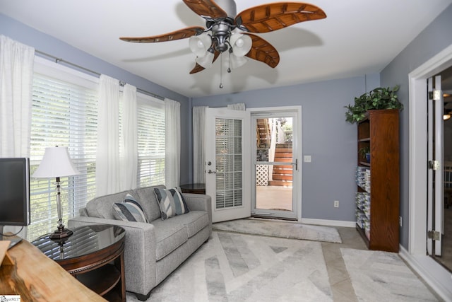 living room with ceiling fan and a healthy amount of sunlight