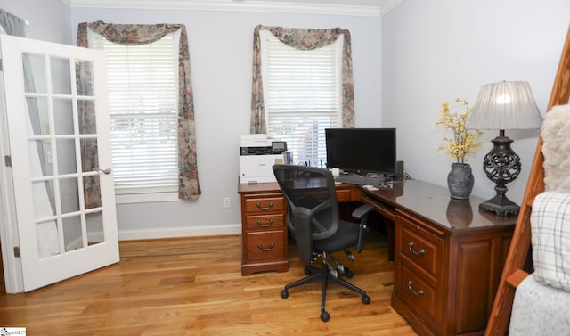 office area featuring light wood-type flooring and ornamental molding