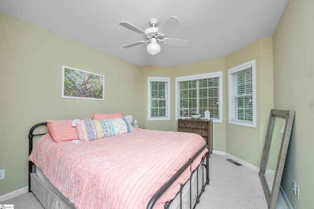 bedroom featuring ceiling fan and light carpet