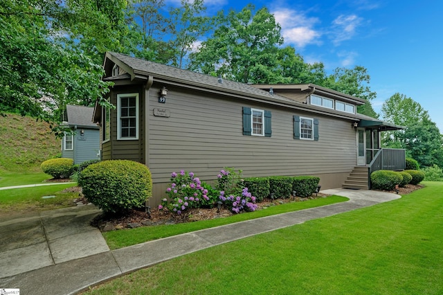 view of side of property with a lawn