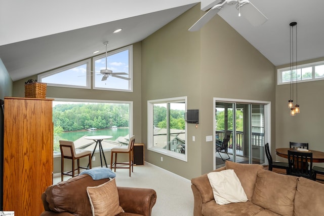 living room featuring carpet, high vaulted ceiling, ceiling fan, and a wealth of natural light