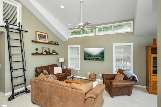 living room featuring a barn door, ceiling fan, high vaulted ceiling, and light colored carpet